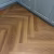 Кварцвиниловый SPC ламинат Vinilam Parquet Herringbone Паркет Винсент IS11200 венгерская елка 720×120×6,5 фото в интерьере