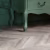 Кварцвиниловая плитка Vinilam клеевая Parquet Chevron Glue Шеврон Шампань RI153616CL4 французская елка 690×115×2,5 фото в интерьере